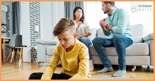 Child in the foreground while his parents argue in the background